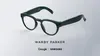 The image shows dark green Google intelligent eyewear frames by Warby Parker.