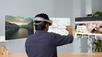 A person seen from behind, wearing the Samsung Galaxy XR headset, sits at a desk and interacts with three floating spatial windows: an immersive video of a city, Google Maps, and a Chrome browser.