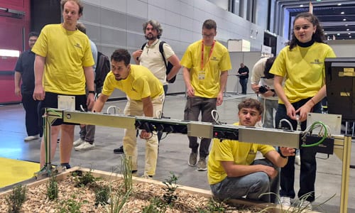 Participants at the VISION Makeathon work on an automated weeding system. Photo: Matthew Peach, optics.org.